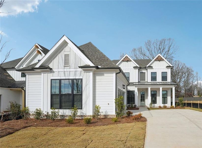 Front exterior of a new home in Promenade at Sawnee Village, Cumming, GA, highlighting curb appeal (Image 21). Front exterior of a new home in Promenade at Sawnee Village, Cumming, GA, highlighting curb appeal (Image 21).