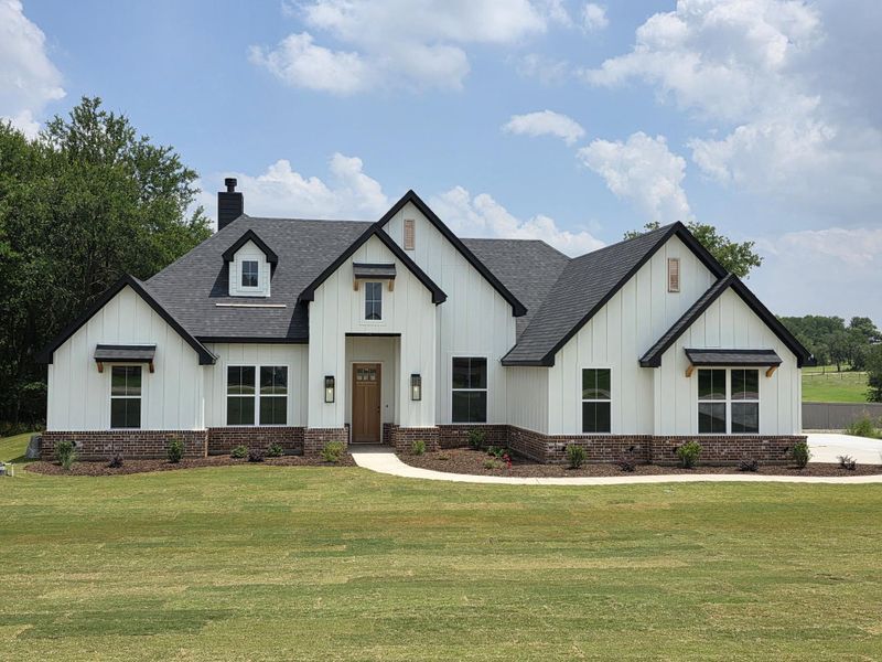Front exterior of a new home in Cartwright Ranch, Weatherford, TX, highlighting curb appeal (Image 1). Front exterior of a new home in Cartwright Ranch, Weatherford, TX, highlighting curb appeal (Image 1).