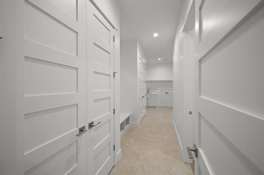 Corridor with recessed lighting and baseboards