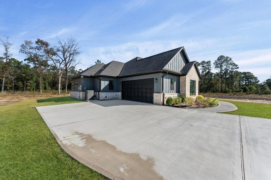 Front exterior of a new home in , Conroe, TX, highlighting curb appeal (Image 1).
