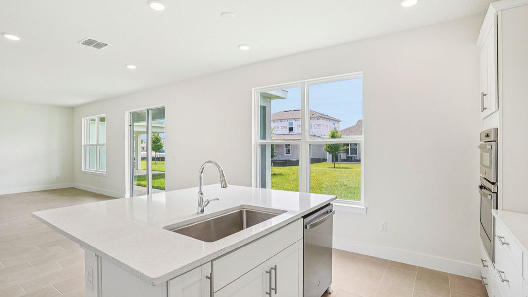 Kitchen sink and quartz island in the Plumeria plan at Lakeside at Satilla by DRB Homes. Kitchen sink and quartz island in the Plumeria plan at Lakeside at Satilla by DRB Homes.