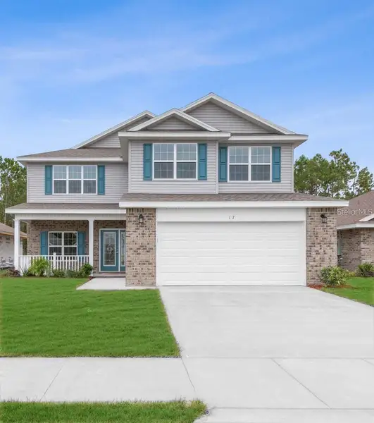 Front exterior of a new home in Palm Coast, Palm Coast, FL, highlighting curb appeal (Image 1). Front exterior of a new home in Palm Coast, Palm Coast, FL, highlighting curb appeal (Image 1).