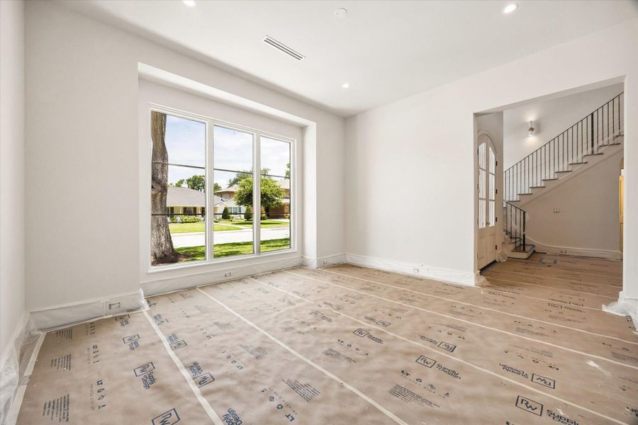 The dining room offers soaring window details and will showcase the Fontaine Chandelier by Visual Comfort.