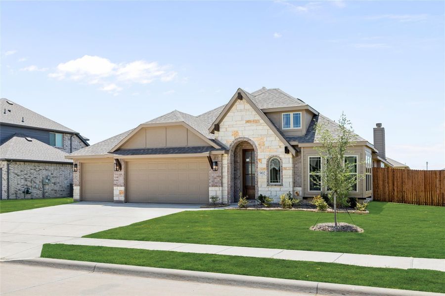 Single-story home with stone and brick exterior, two-car garage, arched entry, and green front lawn. Single-story home with stone and brick exterior, two-car garage, arched entry, and green front lawn.
