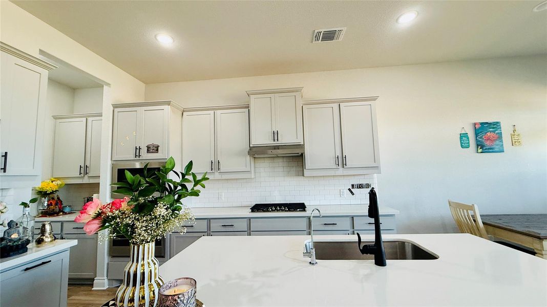 Modern kitchen with sleek cabinetry, a substantial island, and premium appliances for effortless culinary creation.