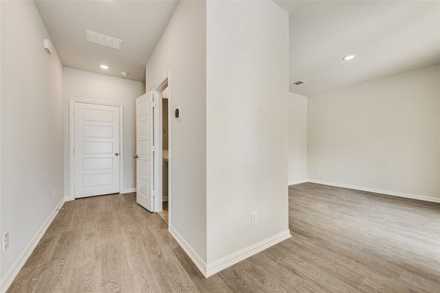 Hall with light hardwood / wood-style flooring