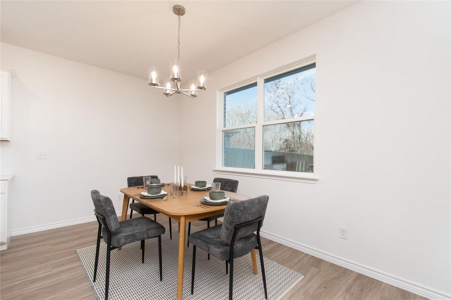 Dining area featuring suspended lighting and light wood finished floors