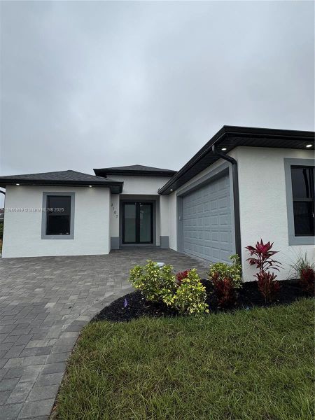Front exterior of a new home in , Lehigh Acres, FL, highlighting curb appeal (Image 1). Front exterior of a new home in , Lehigh Acres, FL, highlighting curb appeal (Image 1).
