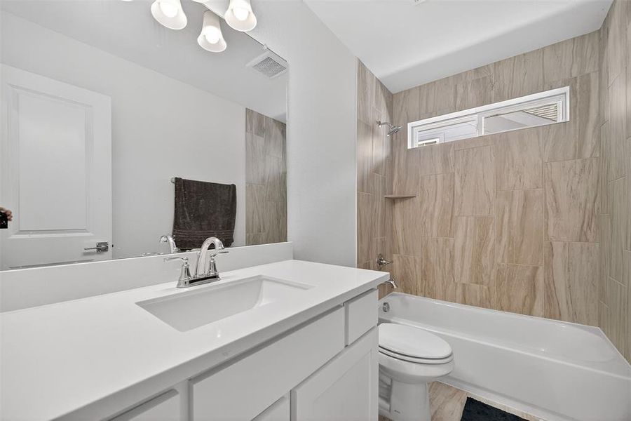 Bathroom featuring bathtub / shower combination and vanity Bathroom featuring bathtub / shower combination and vanity