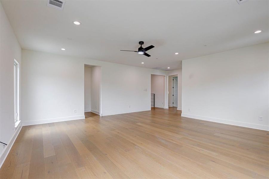 Empty room featuring light wood-style floors, recessed lighting, and a ceiling fan