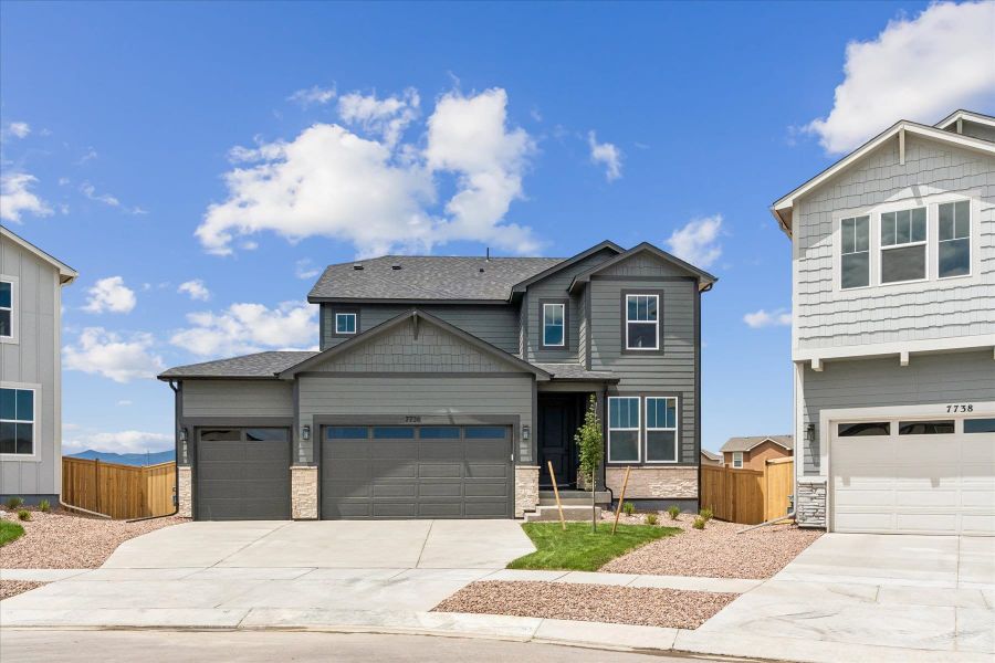 Front exterior of a new home in Aspen Meadows, Colorado Springs, CO, highlighting curb appeal (Image 2).