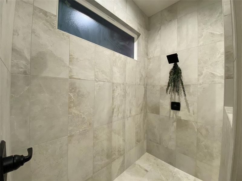 Bathroom featuring a tile shower