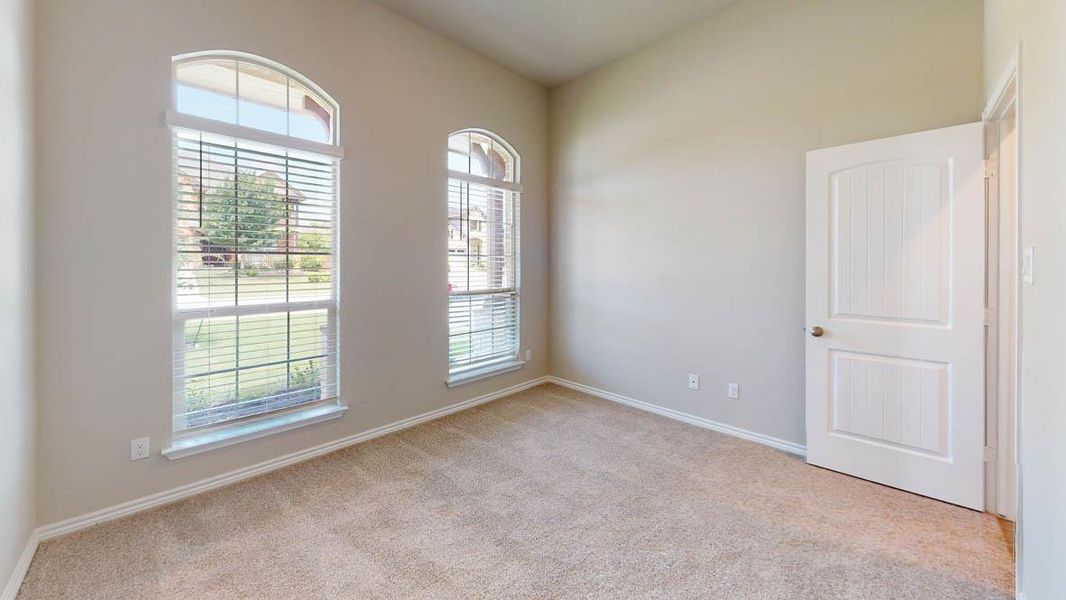 Unfurnished room featuring light colored carpet and baseboards