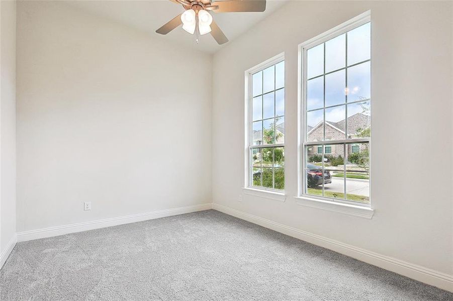 Spare room with carpet and ceiling fan