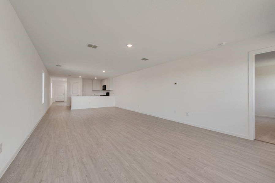 Unfurnished living room featuring light wood finished floors and recessed lighting