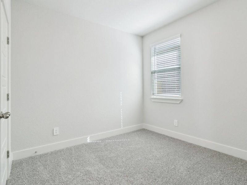 Guest bedroom in the San Saba floorplan at a Meritage Homes community.