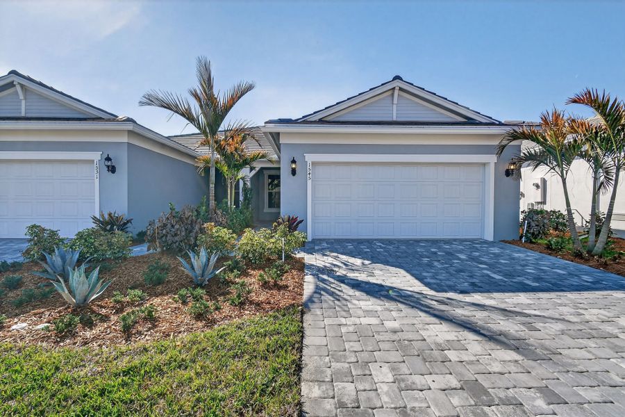 Front exterior of a new home in Costa Pointe, Vero Beach, FL, highlighting curb appeal (Image 28).