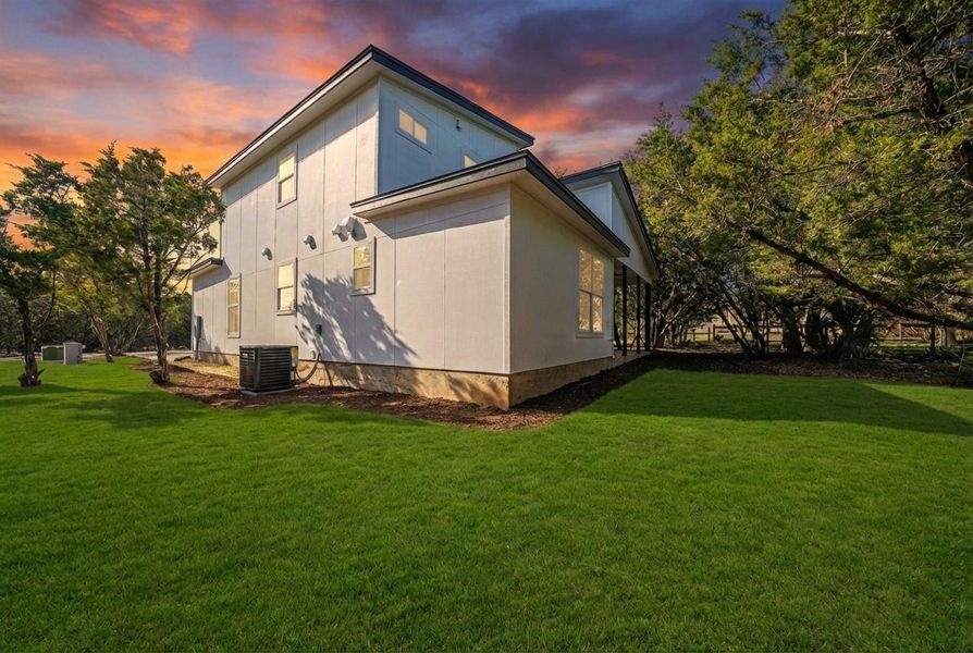 Rear view of property with a lawn