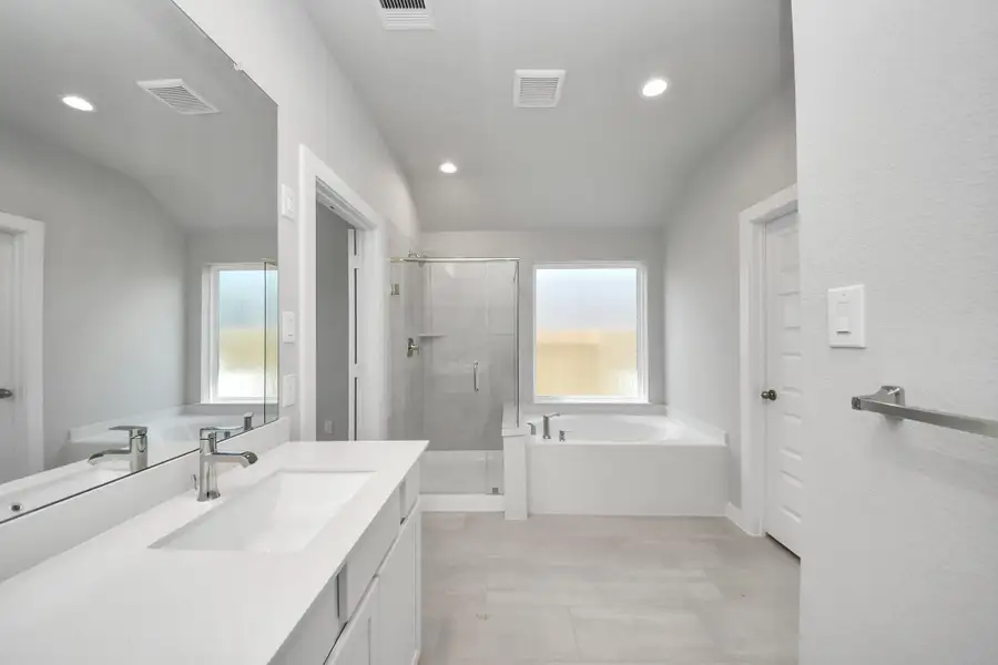 The primary en-suite has a soaking tub to give you that spa experience. The large privacy window allow lots of nature light in the space. Sample photo of completed home with similar floor plan. Actual colors and selections may vary. The primary en-suite has a soaking tub to give you that spa experience. The large privacy window allow lots of nature light in the space. Sample photo of completed home with similar floor plan. Actual colors and selections may vary.