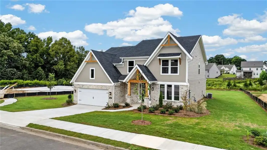 Front exterior of a new home in Hidden Fields, Hoschton, GA, highlighting curb appeal (Image 1). Front exterior of a new home in Hidden Fields, Hoschton, GA, highlighting curb appeal (Image 1).