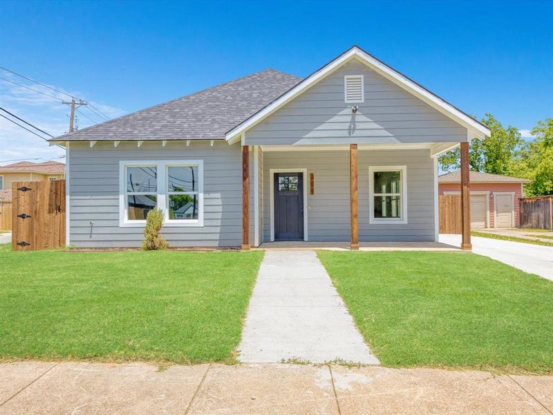 View of front of house with roof with shingles and covered porch