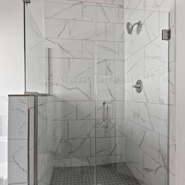 Elegant glass framed walk in shower with high end fixtures. **This image is from another Saratoga Home with similar floor plan - Myrtle Floorplan.** Elegant glass framed walk in shower with high end fixtures. **This image is from another Saratoga Home with similar floor plan - Myrtle Floorplan.**