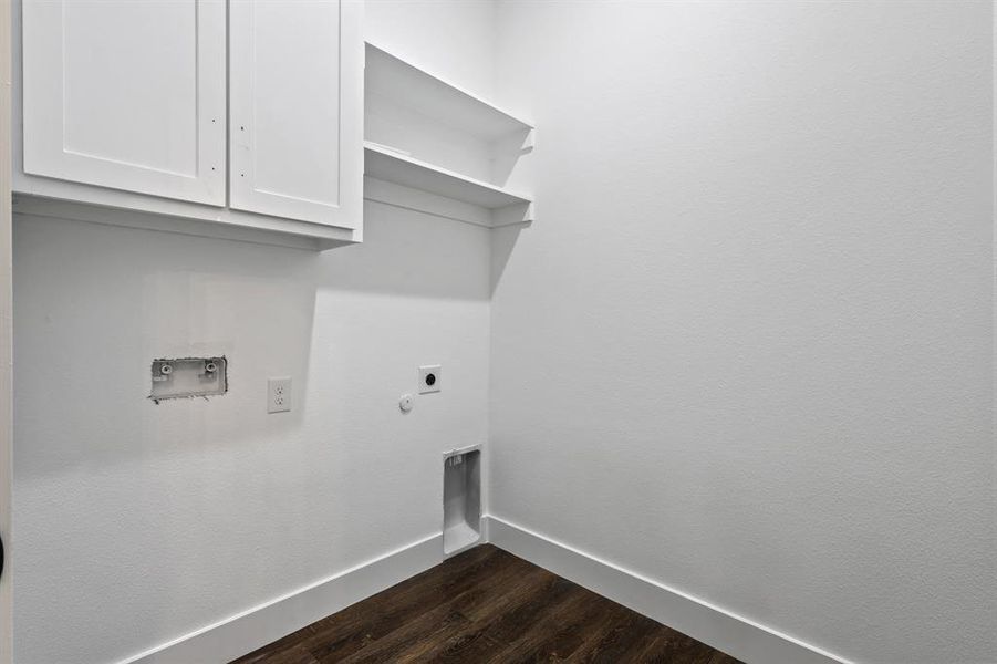 Laundry room featuring washer hookup, cabinets, dark wood-type flooring, and hookup for an electric dryer