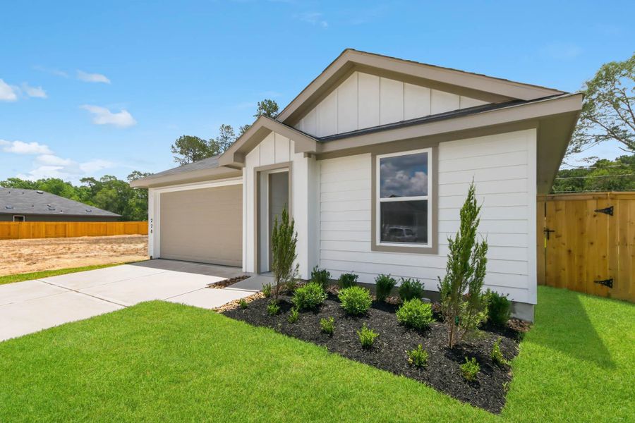 Front exterior of a new home in New Waverly Station, New Waverly, TX, highlighting curb appeal (Image 15). Front exterior of a new home in New Waverly Station, New Waverly, TX, highlighting curb appeal (Image 15).