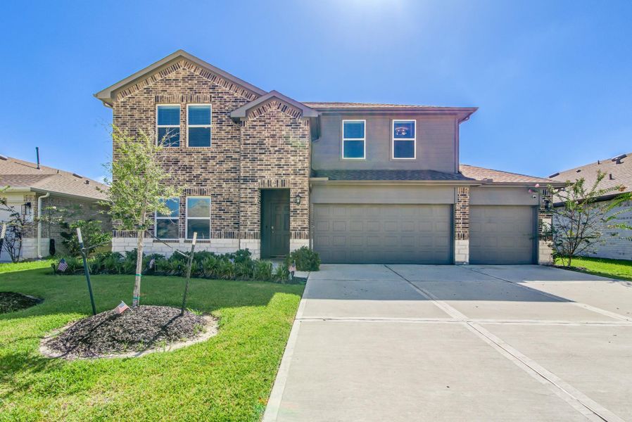 Front exterior of a new home in River Ranch Meadows, Dayton, TX, highlighting curb appeal (Image 27).