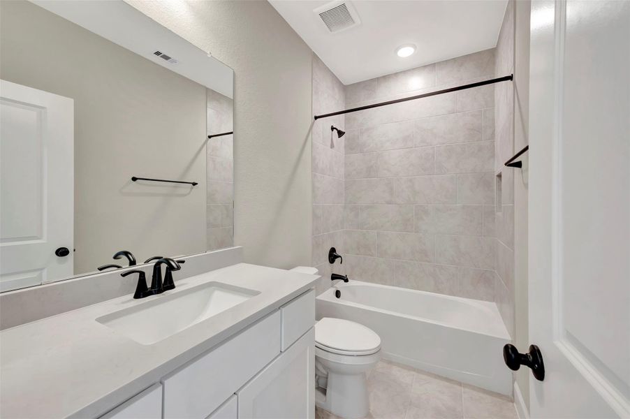 2ndary bath with quartz counters, tile to ceiling