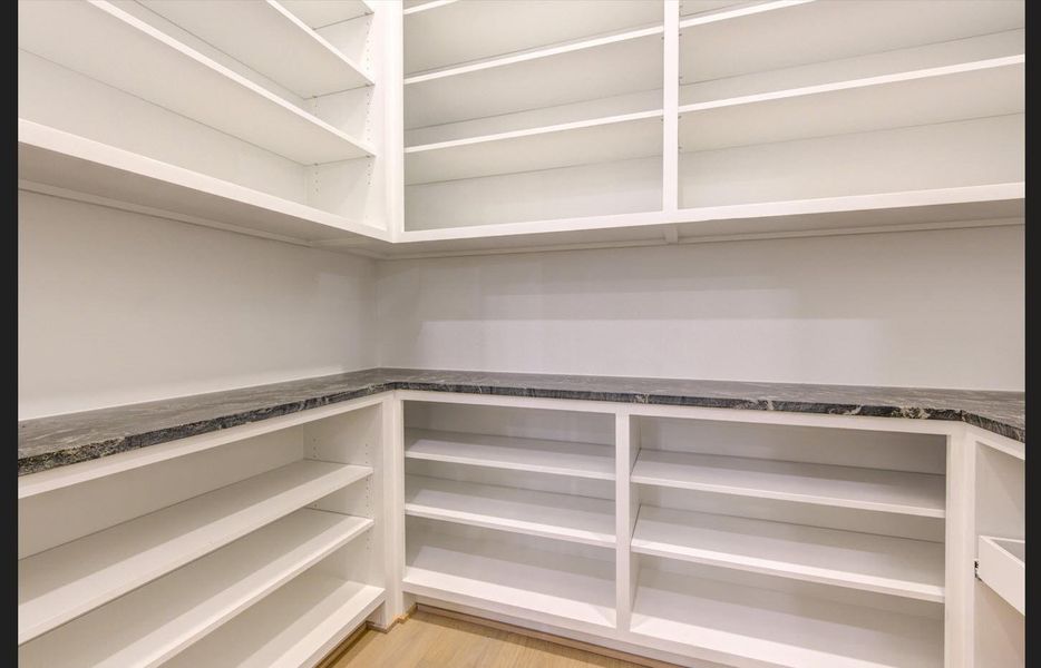 Butler’s Pantry with solid adjustable shelves for flexible storage.