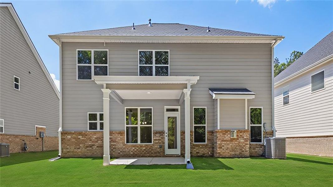 Exterior details and patio area of a home in Evergreen Crossing, Locust Grove (Image 2).