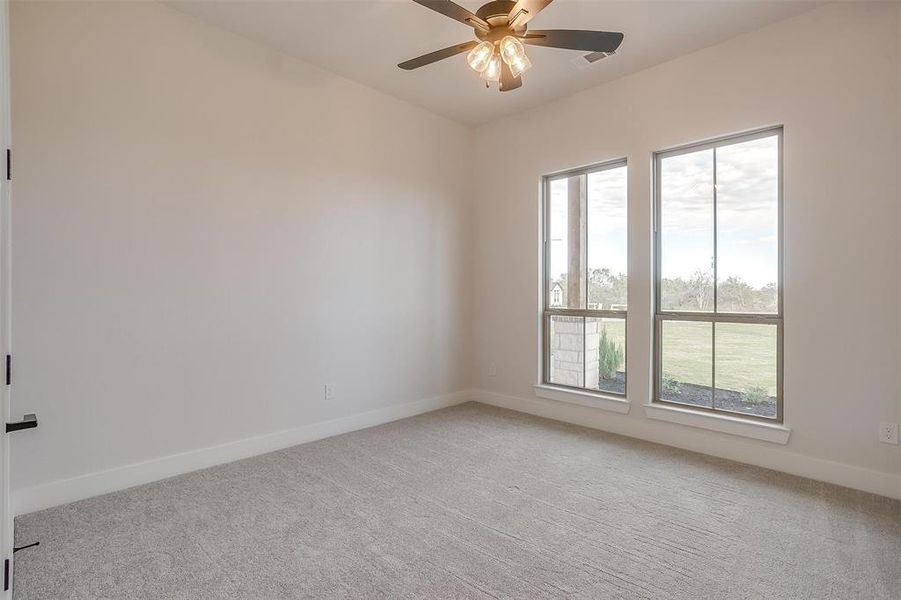 Bedroom 2 with carpet, great windows, fantastic closet and ceiling fan.