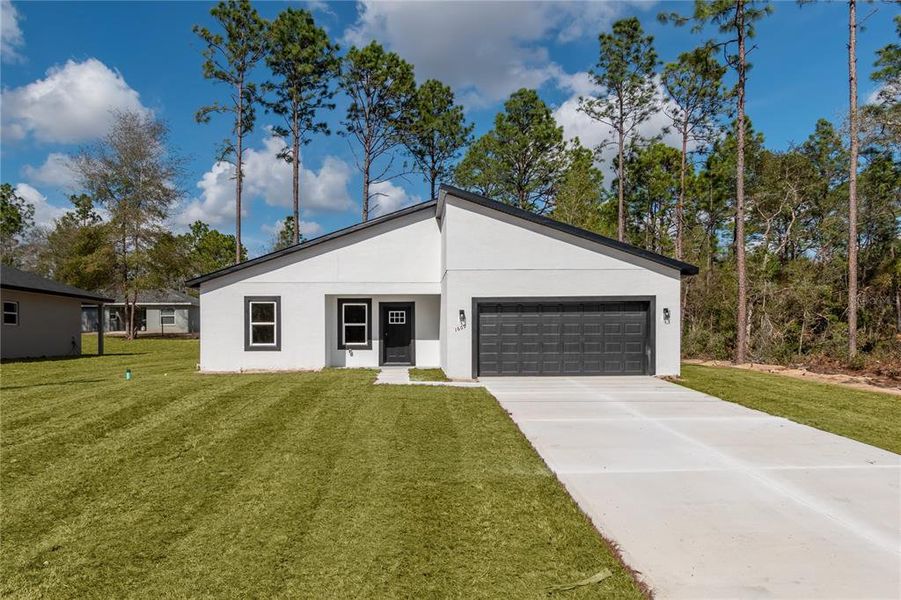 Front exterior of a new home in , Citrus Springs, FL, highlighting curb appeal (Image 27). Front exterior of a new home in , Citrus Springs, FL, highlighting curb appeal (Image 27).