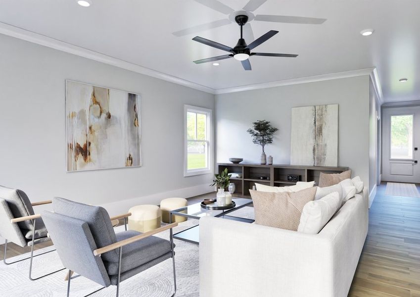 A cozy living room featuring a ceiling fan above a comfortable couch, creating a relaxed atmosphere.