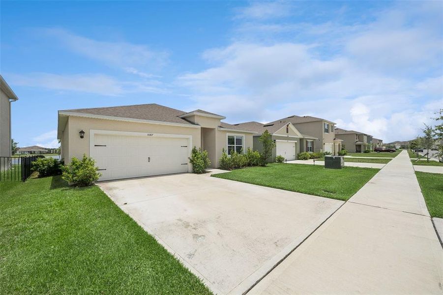 Front exterior of a new home in Buena Lago, St. Cloud, FL, highlighting curb appeal (Image 2).