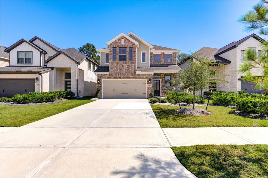 Front exterior of a new home in Harper’s Preserve, Conroe, TX, highlighting curb appeal (Image 1).