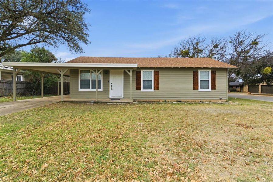 View of front of property with a porch, concrete driveway, a carport, and roof with shingles View of front of property with a porch, concrete driveway, a carport, and roof with shingles