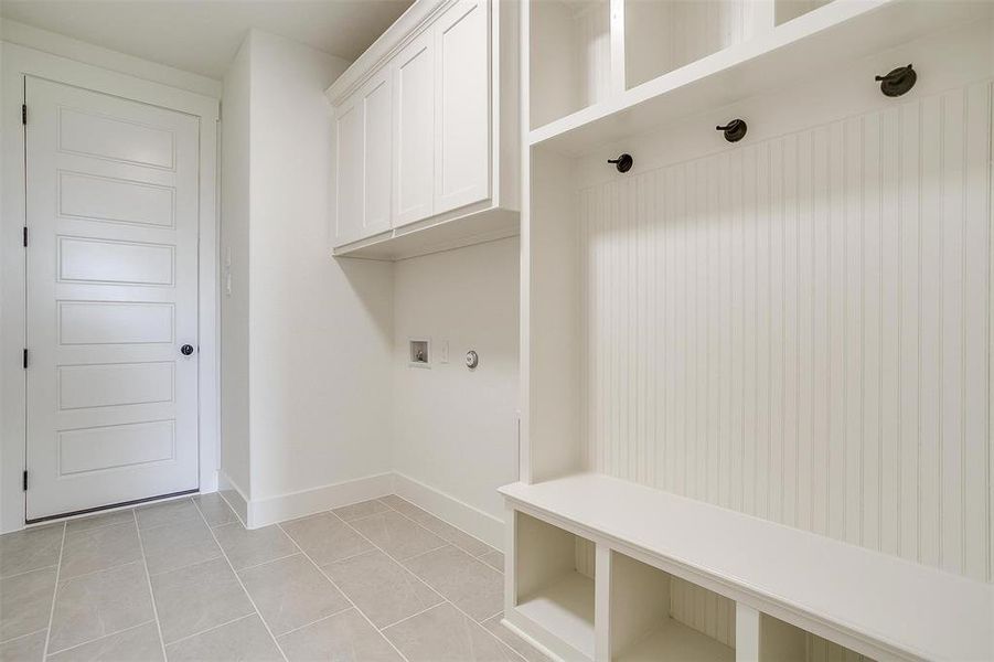 Mudroom with light tile patterned floors