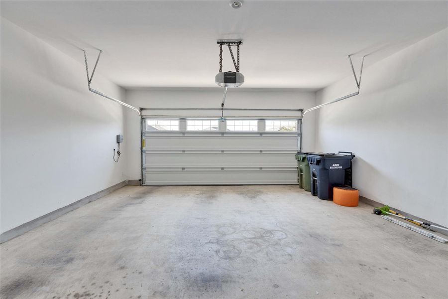 Two car garage with water heater and water softener. Two car garage with water heater and water softener.