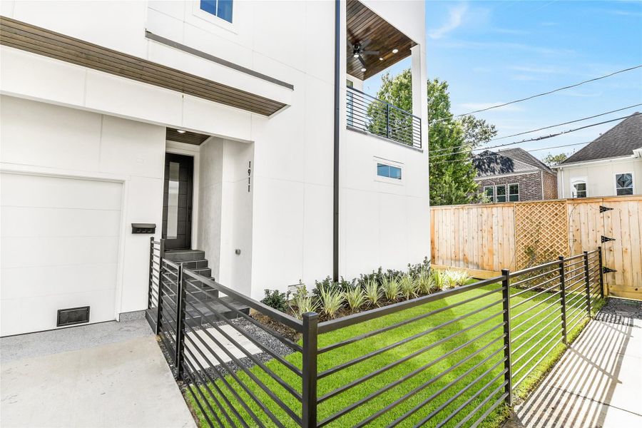 Enjoy the perfect balance of security and serenity with a fully gated front lawn and clean modern fencing. The covered entryway leads to a striking modern front door and a stylish balcony above, setting the tone for a home that blends architectural precision with everyday ease. Perfect for on-call physicians or medical professionals craving a peaceful retreat after long hours at the hospital. Enjoy the perfect balance of security and serenity with a fully gated front lawn and clean modern fencing. The covered entryway leads to a striking modern front door and a stylish balcony above, setting the tone for a home that blends architectural precision with everyday ease. Perfect for on-call physicians or medical professionals craving a peaceful retreat after long hours at the hospital.