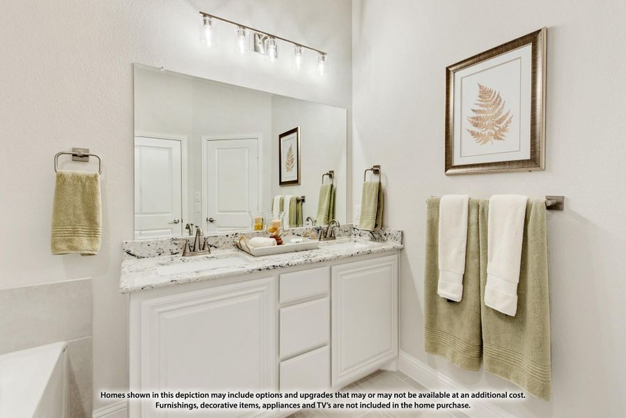 Bathroom with double-sink vanity, white cabinets, granite countertops, and large mirror with overhead lighting Bathroom with double-sink vanity, white cabinets, granite countertops, and large mirror with overhead lighting
