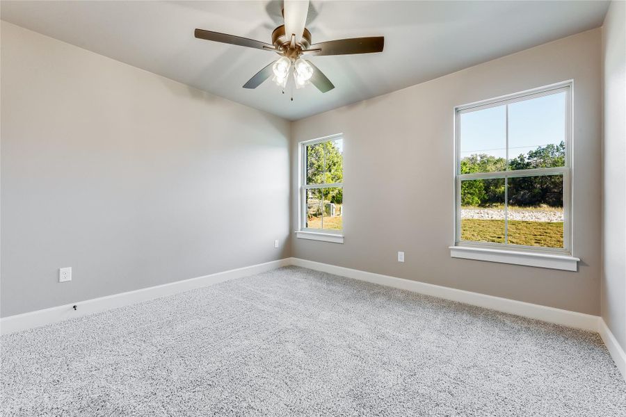 Spare room featuring light colored carpet and ceiling fan Spare room featuring light colored carpet and ceiling fan