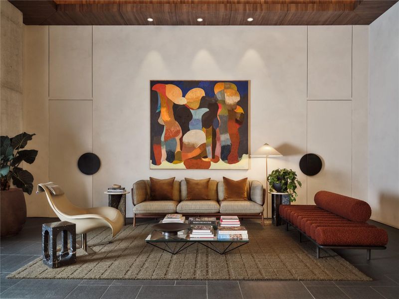 Dramatic wood-paneled ceiling detailing and architectural stone tile flooring anchor this expansive space. Dramatic wood-paneled ceiling detailing and architectural stone tile flooring anchor this expansive space.