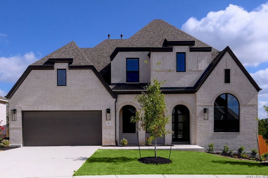 Front exterior of a new home in La Cima, San Marcos, TX, highlighting curb appeal (Image 1). Front exterior of a new home in La Cima, San Marcos, TX, highlighting curb appeal (Image 1).