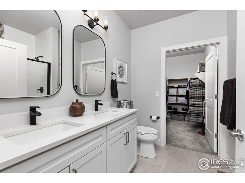 Primary bath with quartz counters and dual sinks.