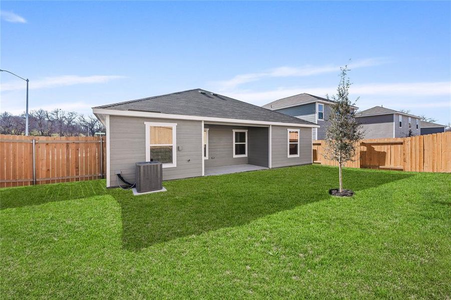 Back of property with central AC, a patio area, and a shingled roof