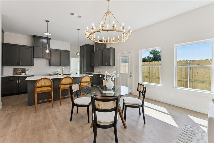 Dining room featuring a chandelier and light wood-style floors