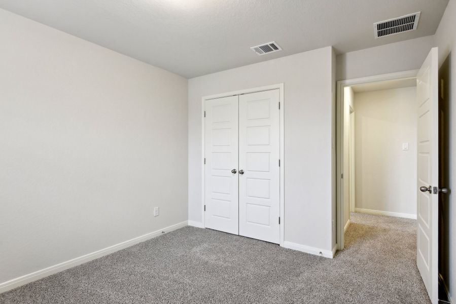 Guest bedroom in the Red River floorplan at a Meritage Homes community.