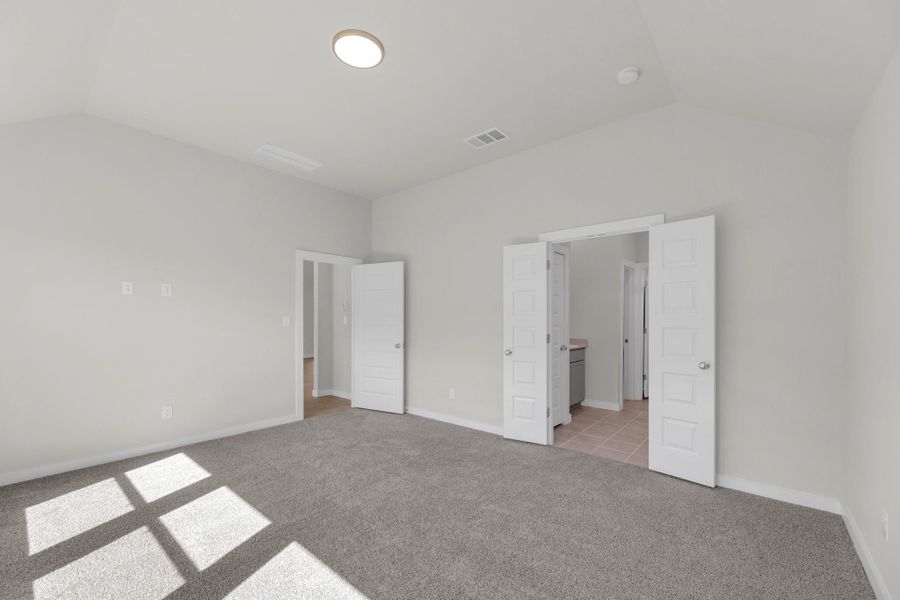 Primary Suite in the Evelyn Pecos model home in Austin TX by Trophy Signature Homes